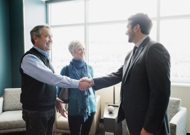 Couple shaking advisor's hand